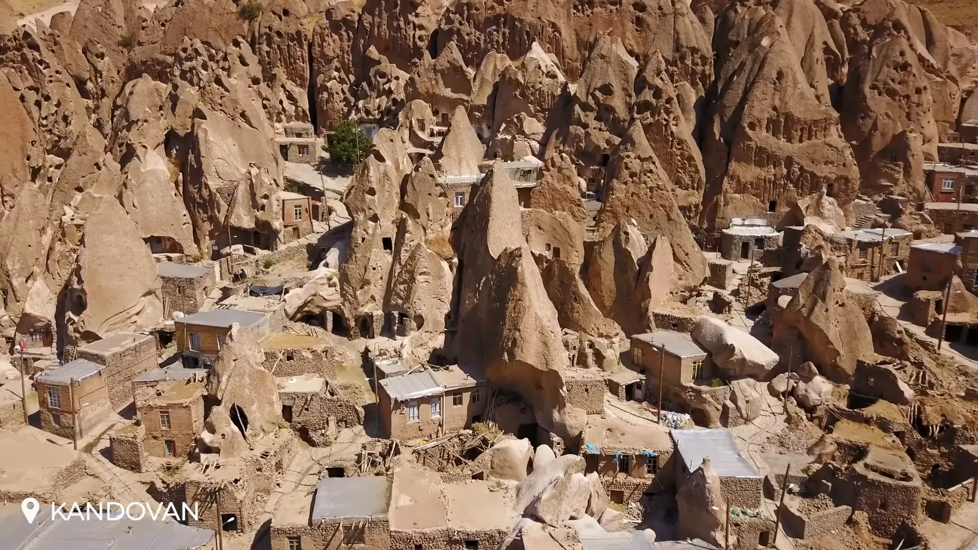Rock-hewn houses of Kandovan built into volcanic cones with small windows and doors