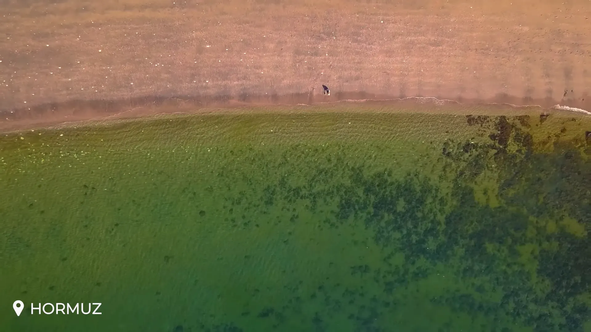 Hormuz Island's vividly colored cliffs and minerals by turquoise waters