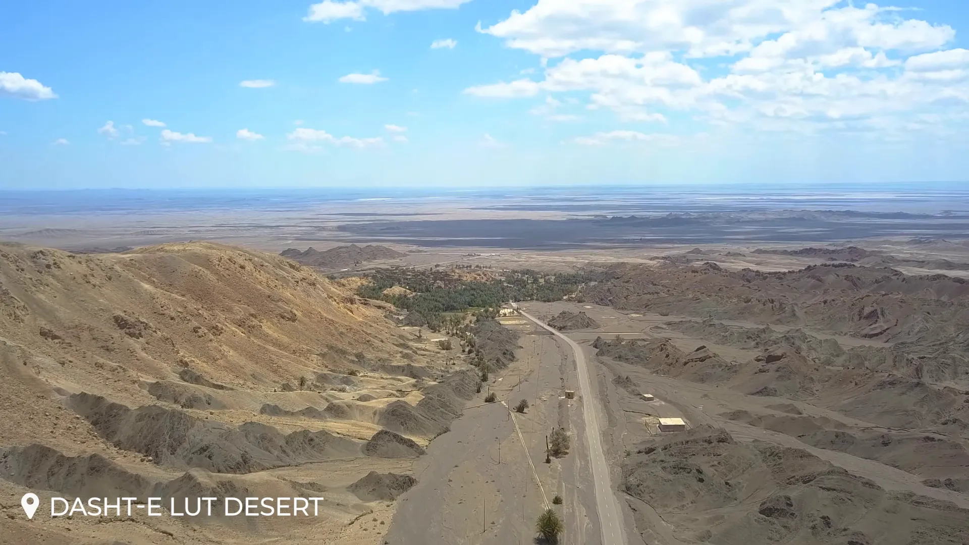Wind-sculpted yardangs in the Lut Desert under a clear blue sky
