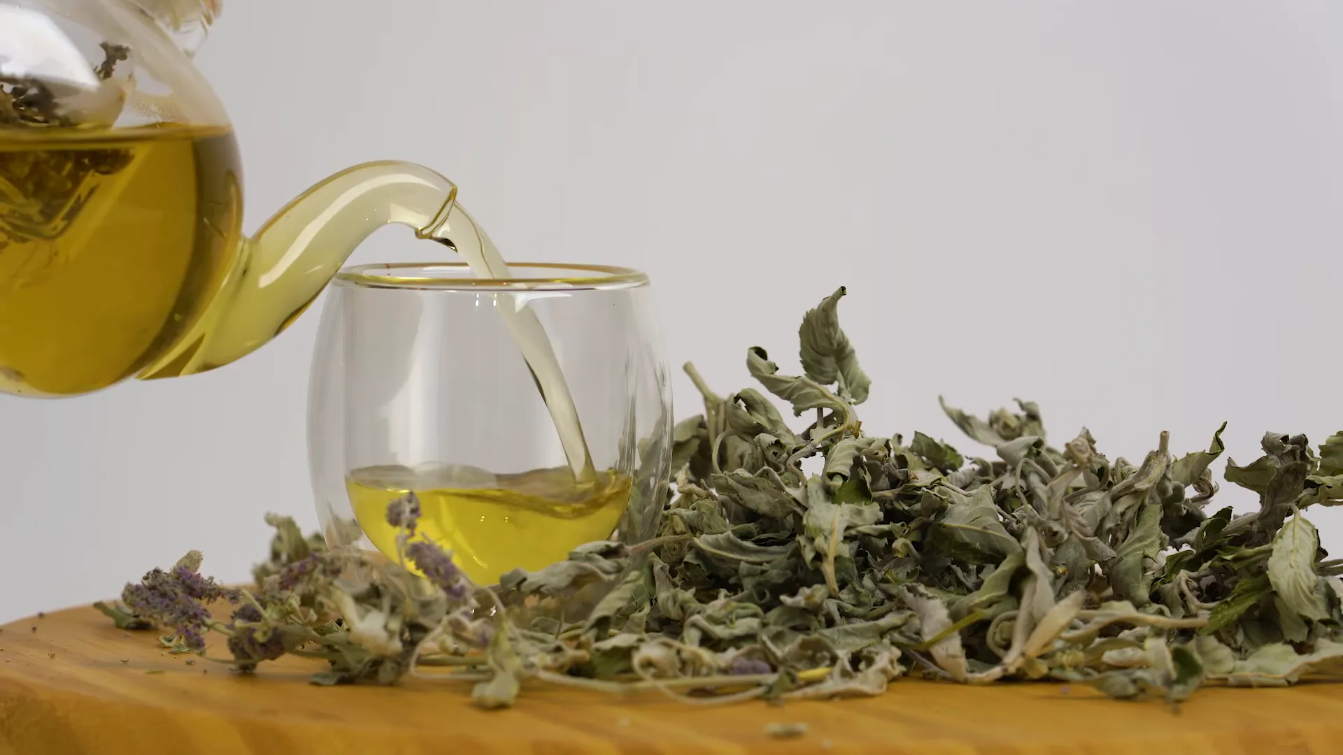 Traditional tea being poured into a glass cup in a tea house showing hospitality
