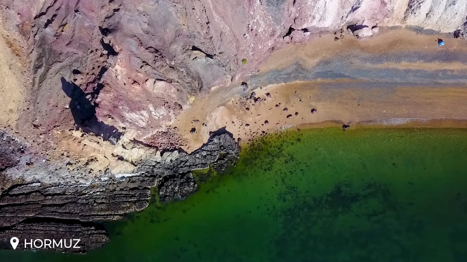 Women on Hormuz Island preparing pigments from red soil for crafts