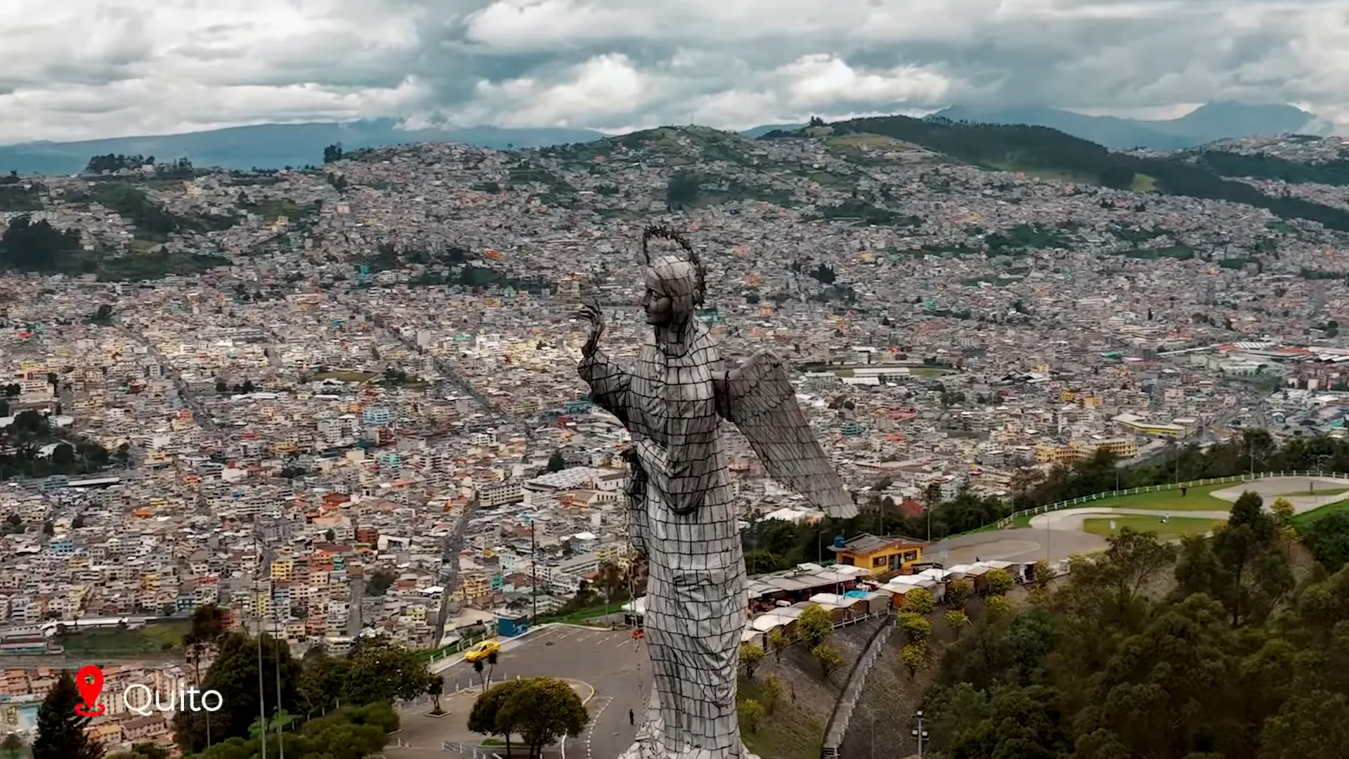 Cotopaxi volcano towering above paramo grasslands with hikers in the foreground
