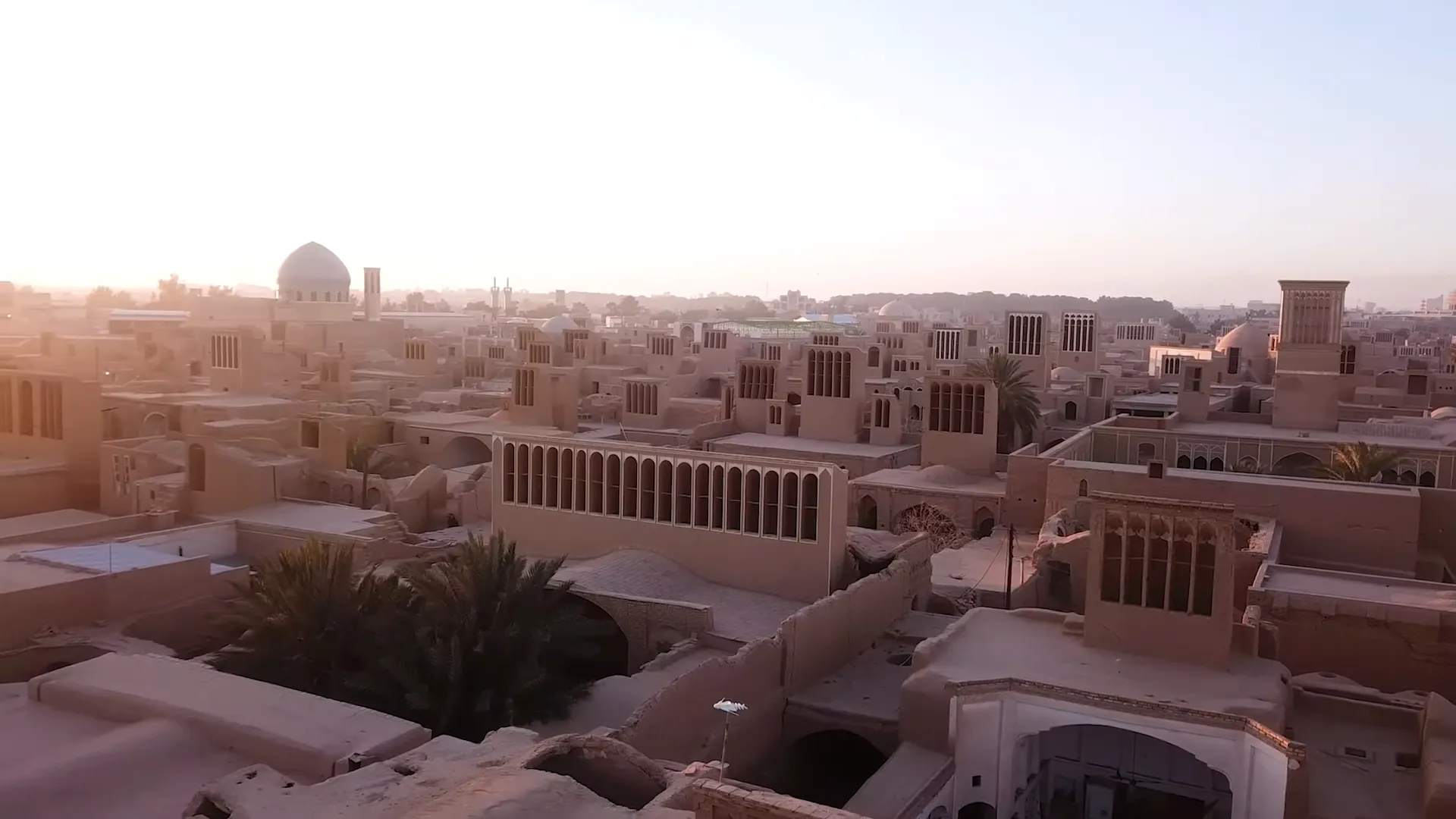 Traveler using a laptop in a traditional courtyard cafe—digital nomad working in Iran