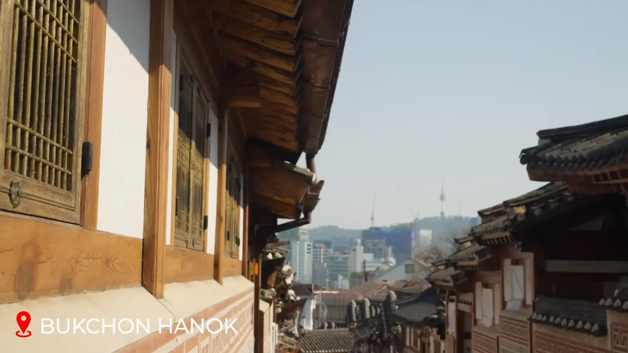 Narrow alley of Bukchon Hanok Village with traditional tiled rooftops and wooden doors