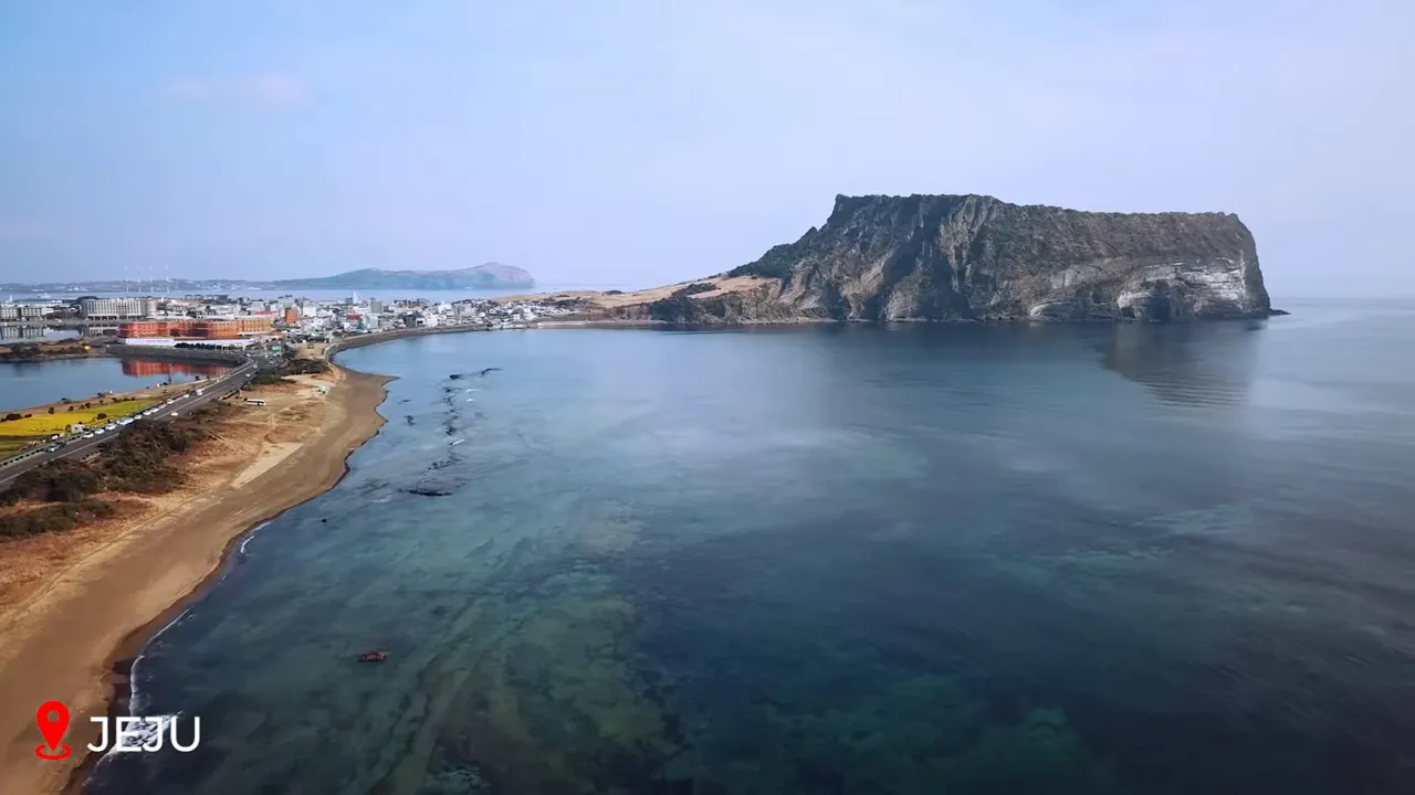 Seongsan Ilchulbong rising from the sea with a golden sunrise