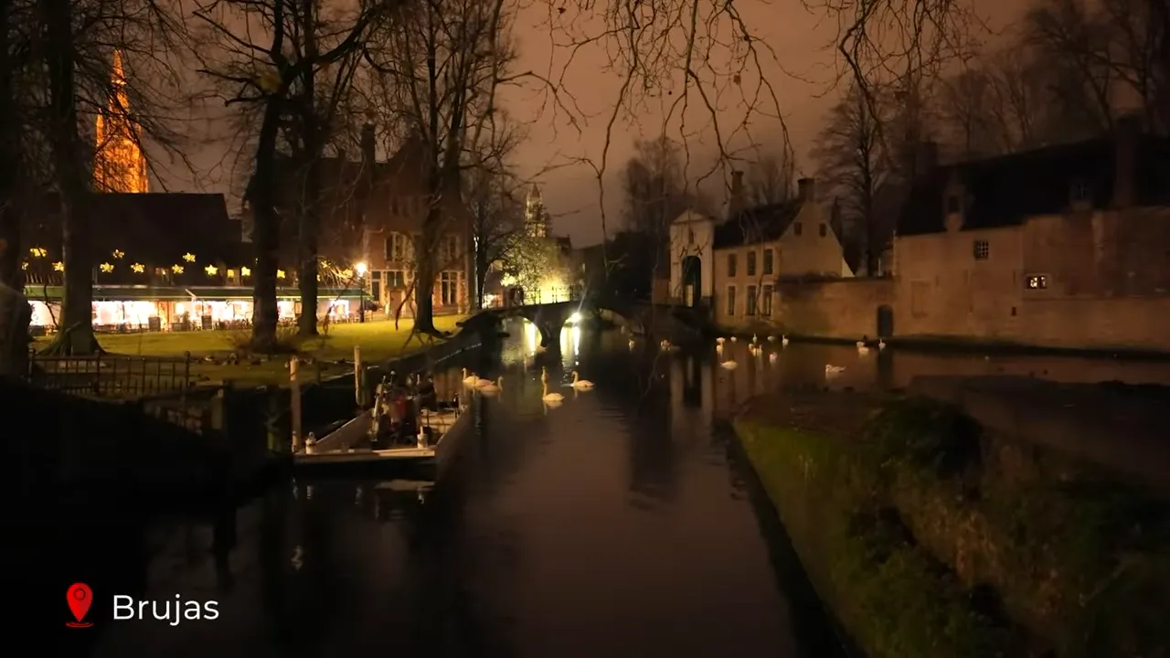 Bruges canals at night with Christmas lights reflecting in the water