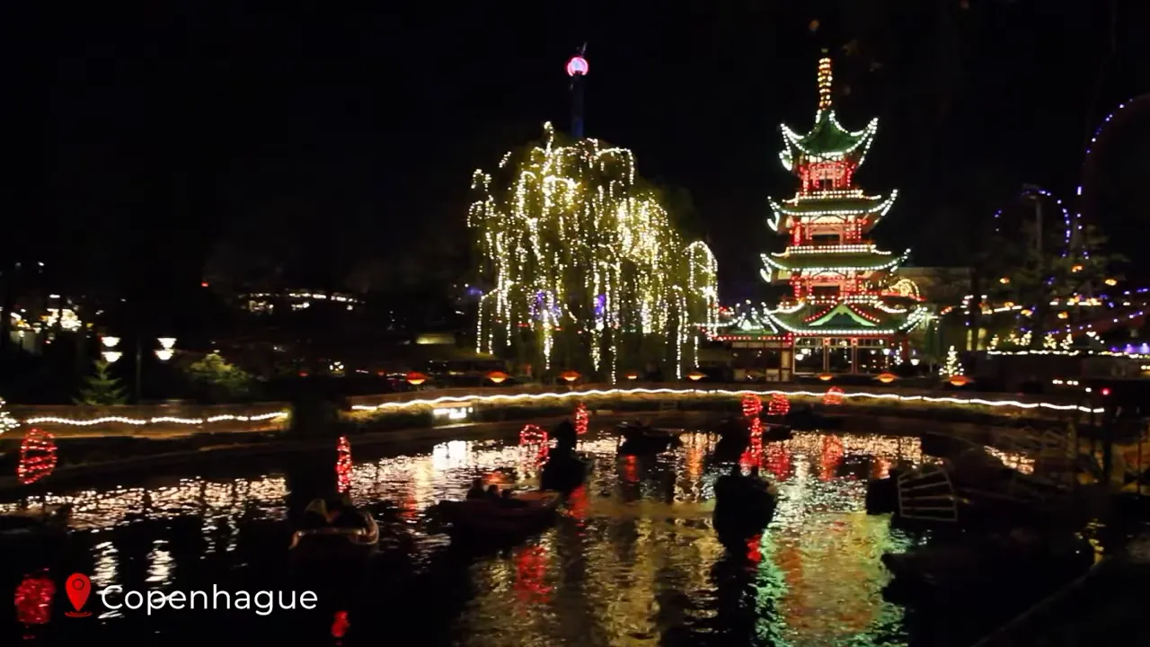 Tivoli Gardens lit up with festive lights and a carousel