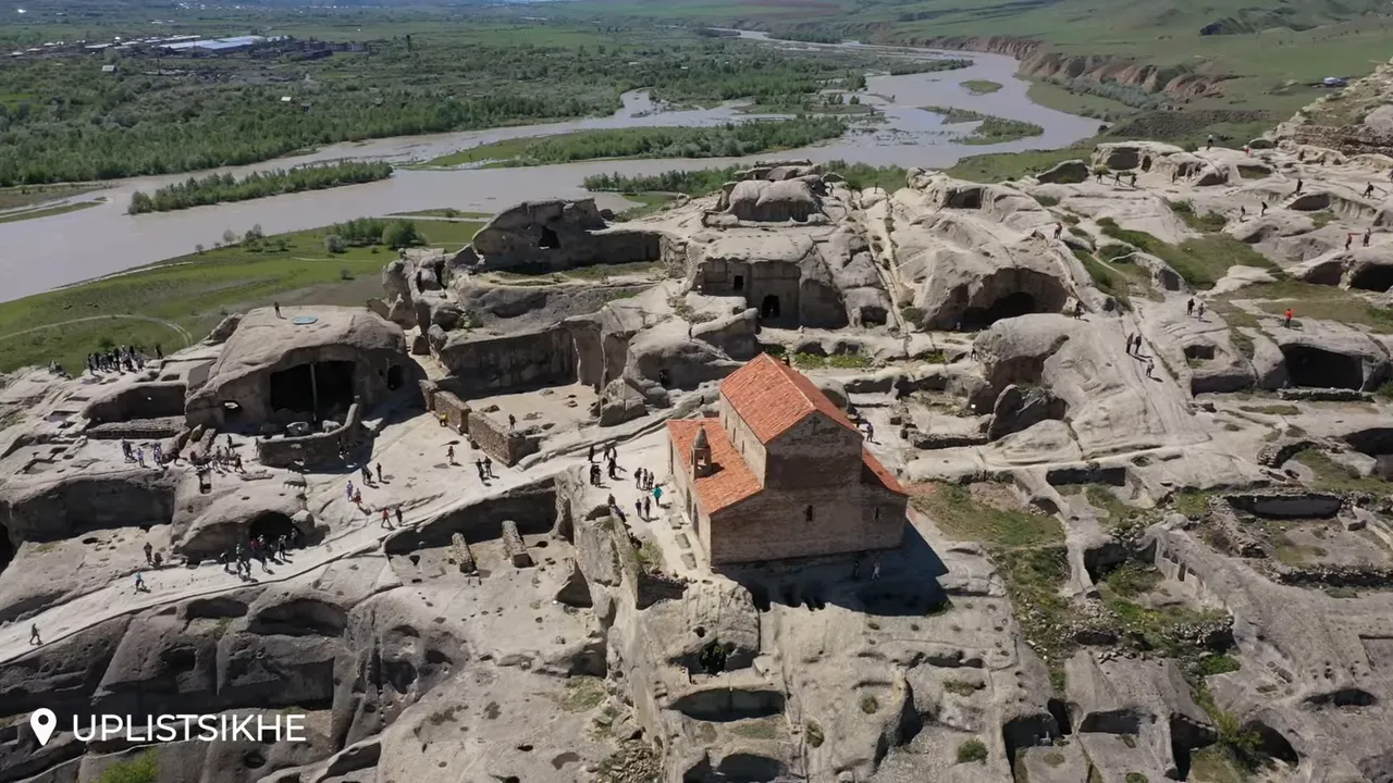 Aerial view of Uplistsikhe showing hilltop church, carved caves and the river valley