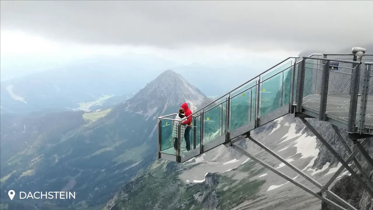 Glass viewing platform projecting over a high mountain valley in Dachstein