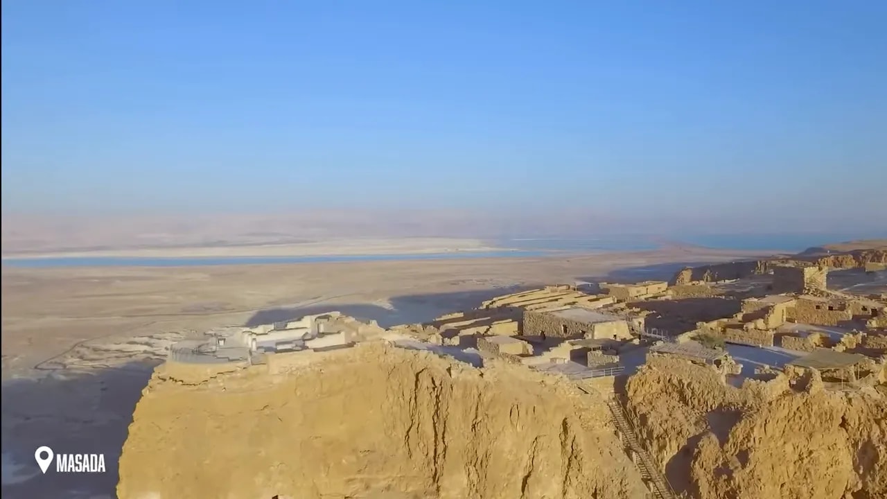 Aerial view of the Masada plateau with ruins and desert cliffs
