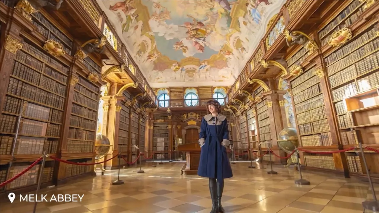 Ornate Melk Abbey library with tall shelves and painted ceiling