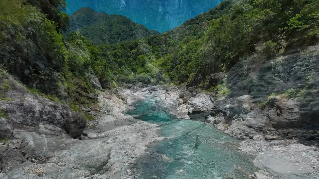 Turquoise river flowing between steep rocky walls in Taroko Gorge