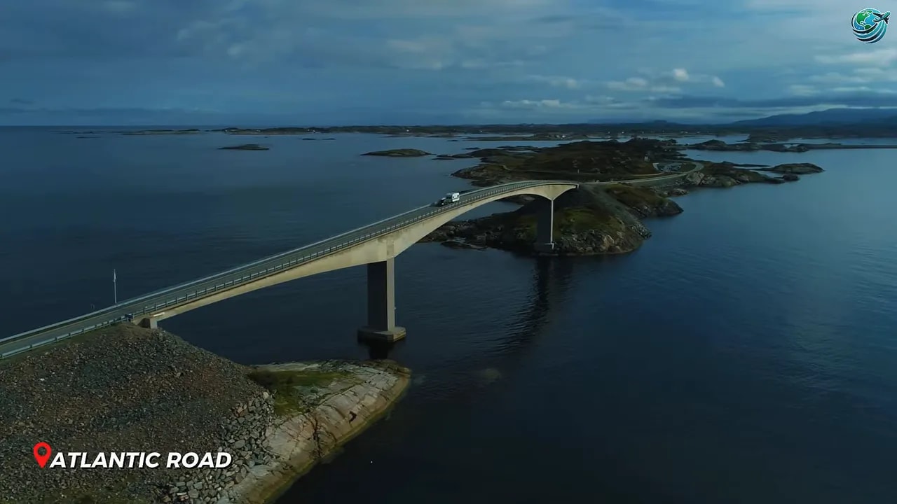Curved bridge crossing dark blue water on Atlantic Ocean Road