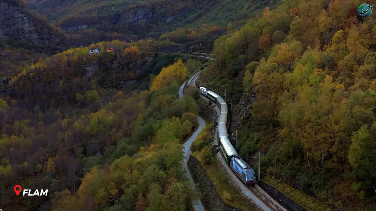 Train traveling through a green mountain valley